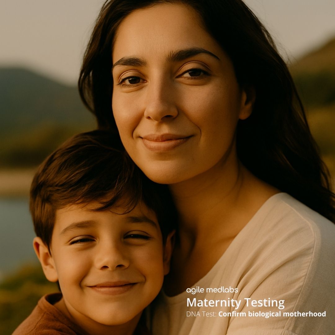 Mother smiling at baby while holding her on a couch — used on Agile MedLabs’ Maternity DNA Test page.
